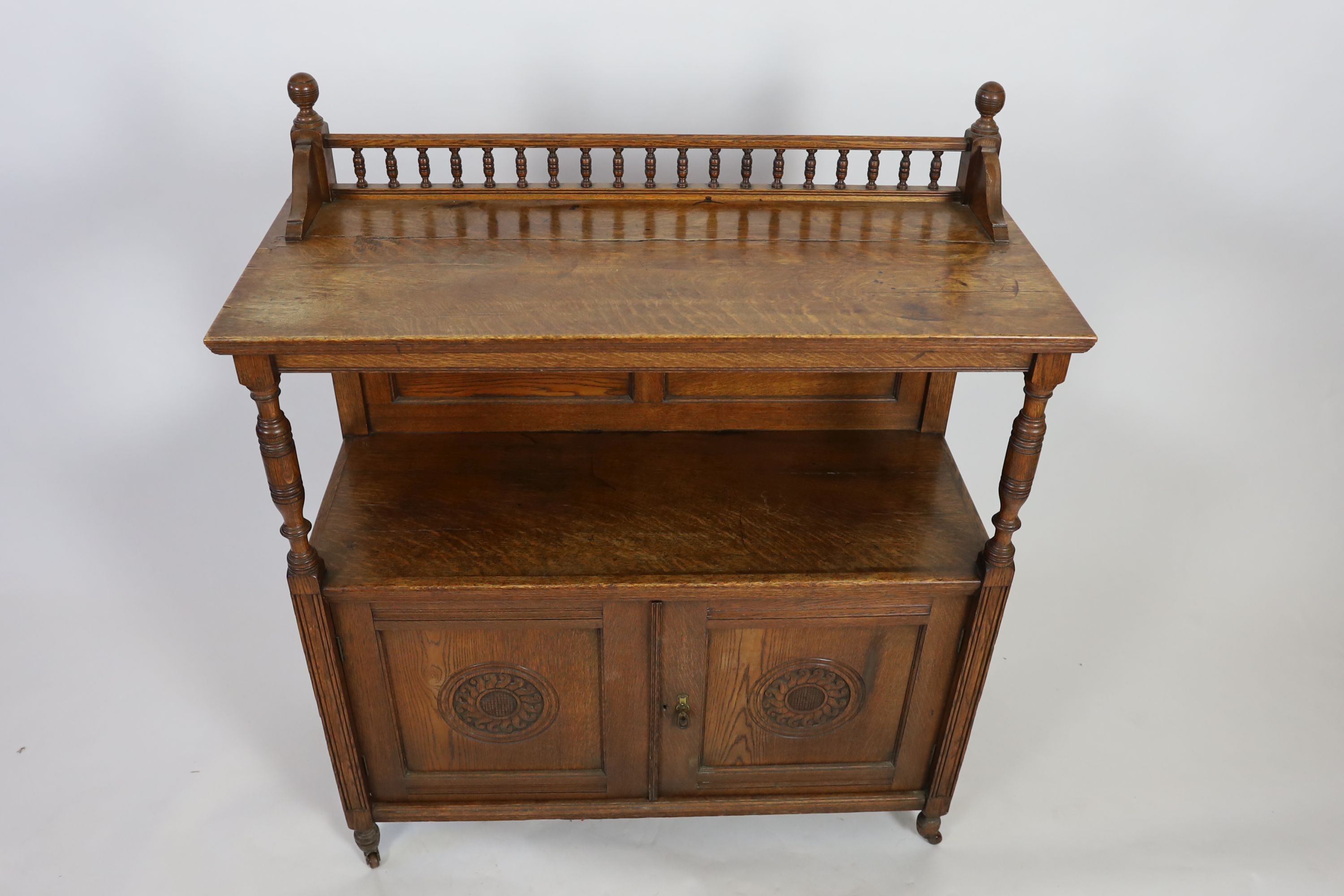 A late Victorian oak buffet, width 113cm depth 47cm height 133cm